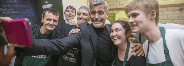 George Clooney taking a selfie with a group of workers
